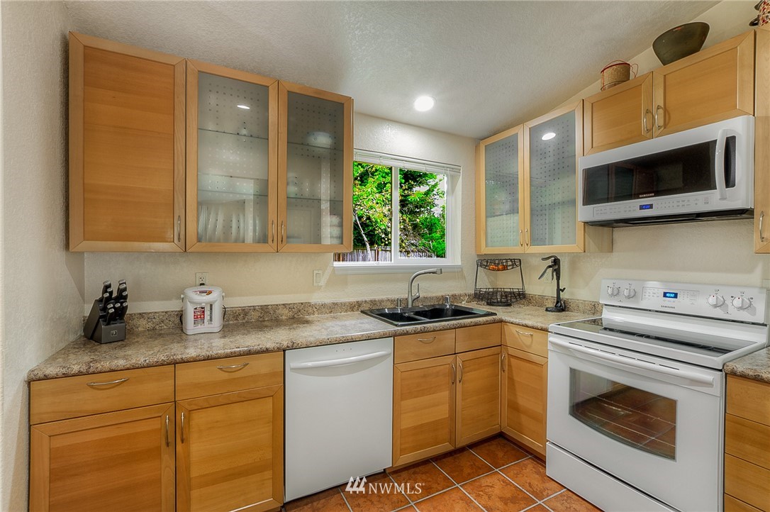 2111 Wells Court South Renton, WA 98055 - Photo 6 of 25 a kitchen with stainless steel appliances granite countertop a sink stove and microwave