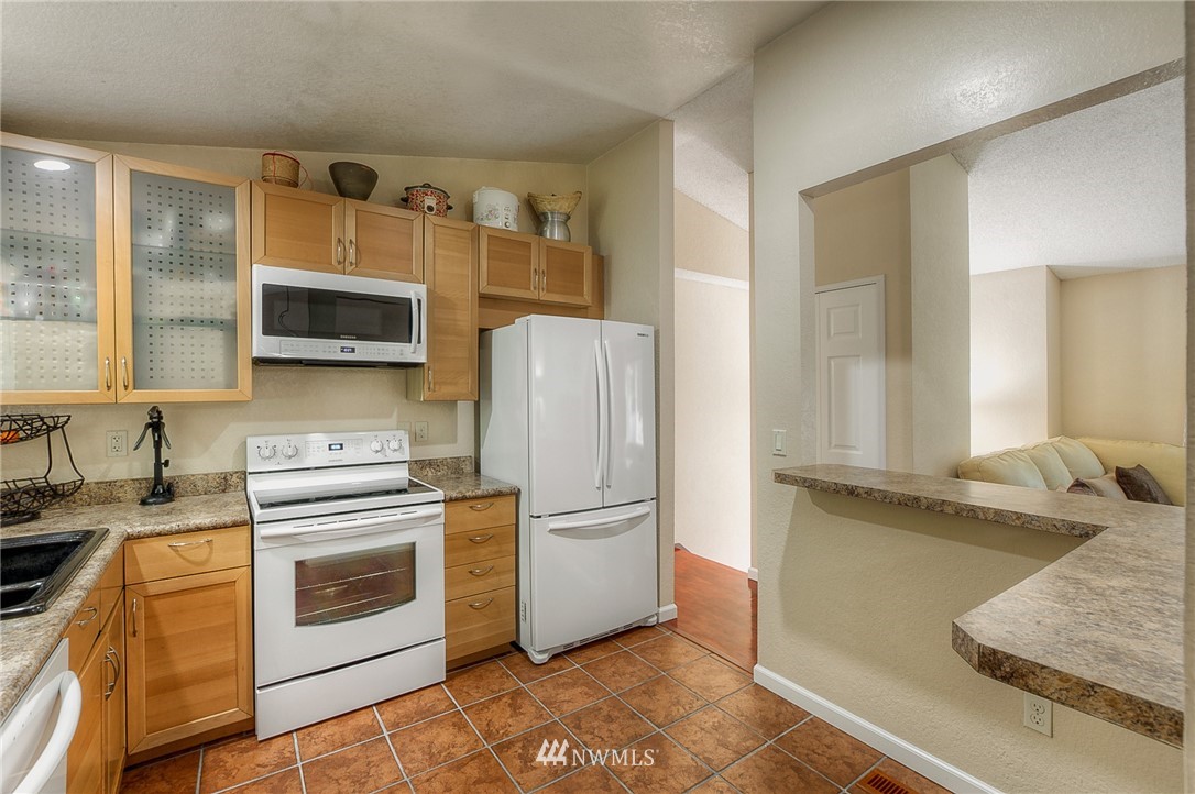 2111 Wells Court South Renton, WA 98055 - Photo 8 of 25 a kitchen with stainless steel appliances granite countertop a refrigerator sink and stove