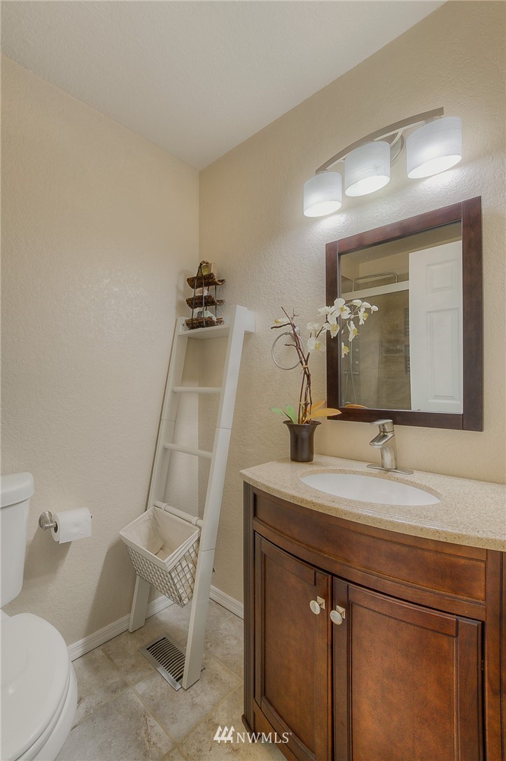 2111 Wells Court South Renton, WA 98055 - Photo 10 of 25 a bathroom with a sink a toilet and mirror