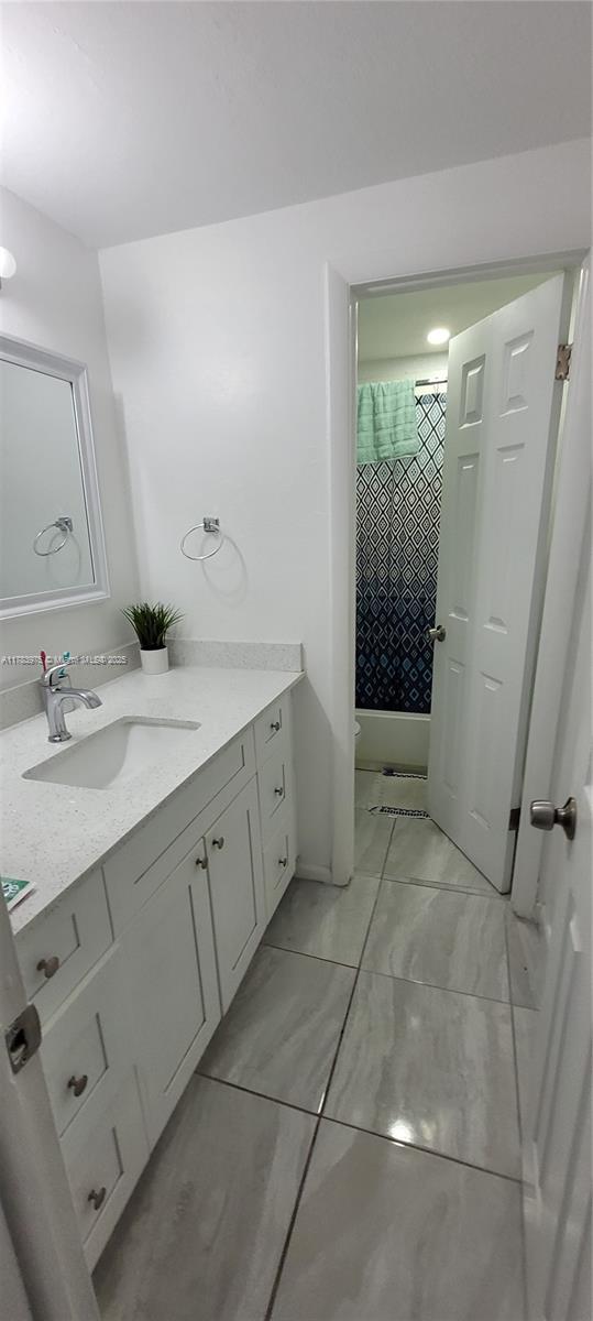 20007 Southwest 123rd Drive Miami, FL 33177 - Photo 15 of 18 a spacious bathroom with a double vanity sink and a mirror
