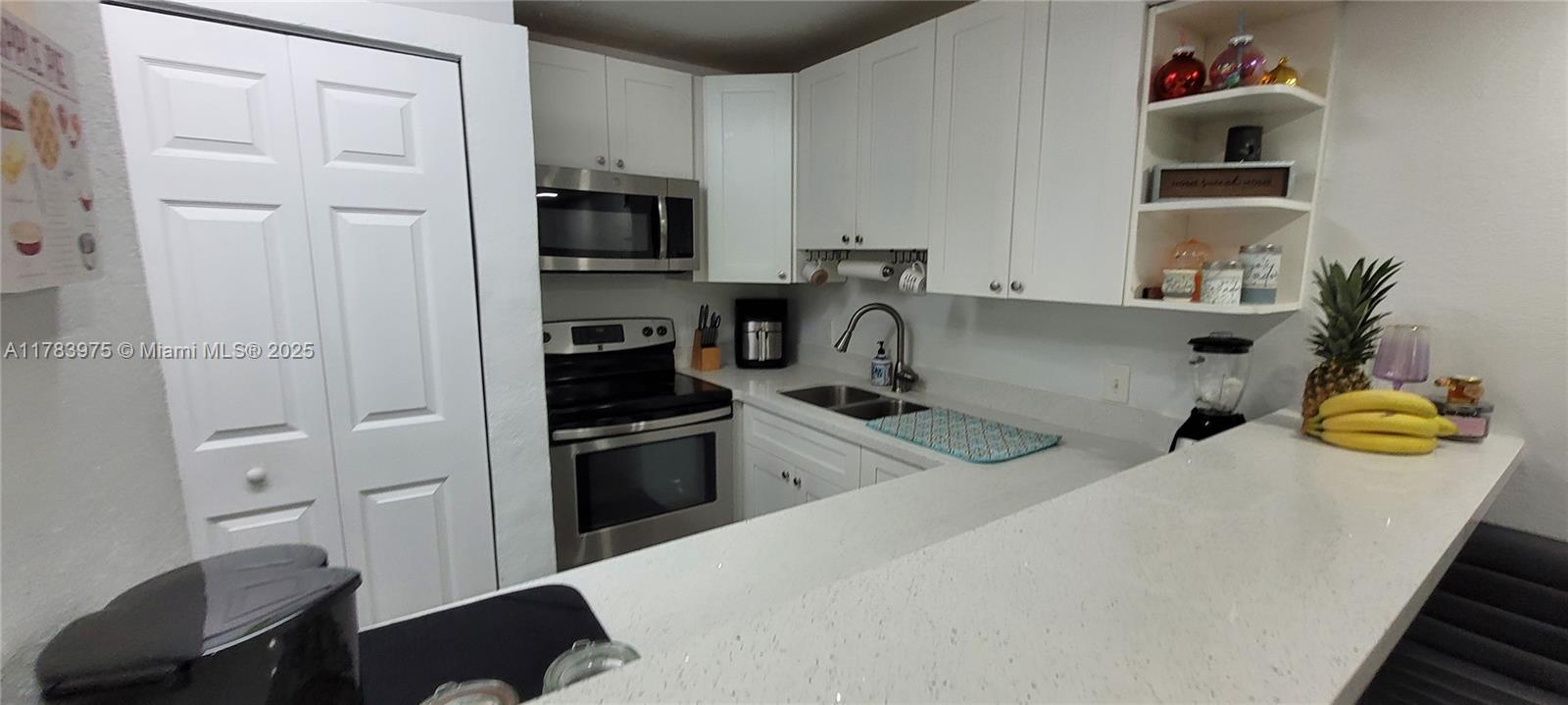 20007 Southwest 123rd Drive Miami, FL 33177 - Photo 2 of 18 a kitchen with stainless steel appliances granite countertop a sink and a refrigerator
