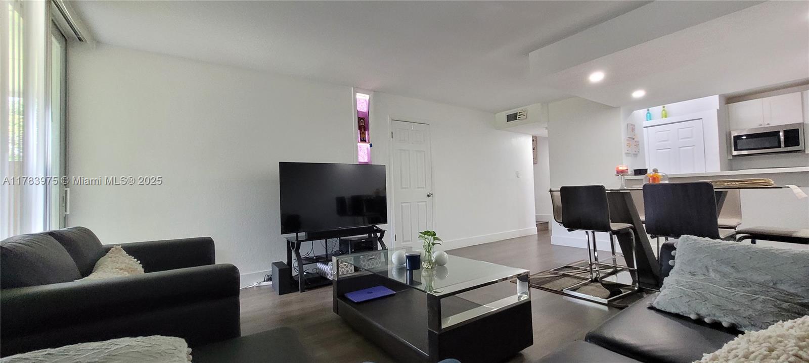 20007 Southwest 123rd Drive Miami, FL 33177 - Photo 7 of 18 a living room with furniture and a flat screen tv