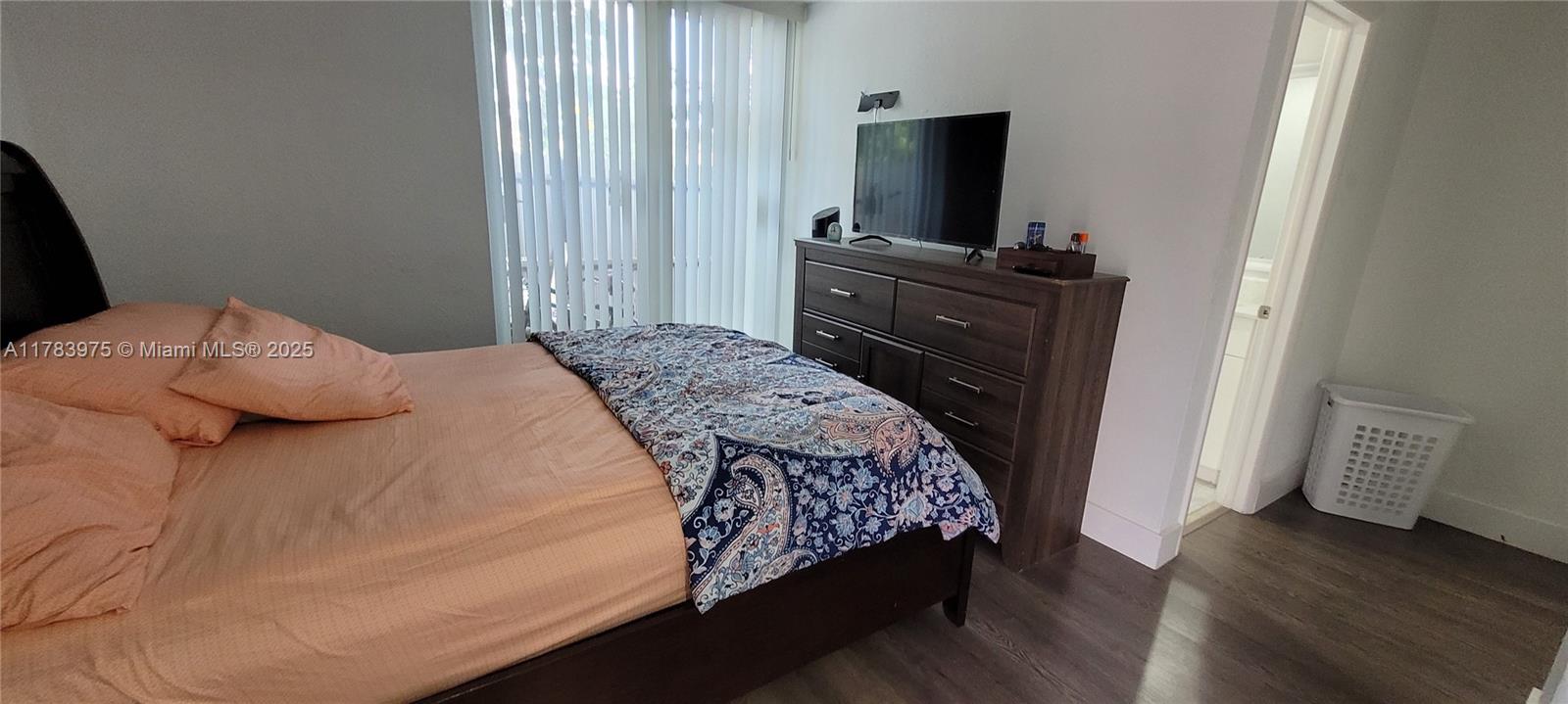 20007 Southwest 123rd Drive Miami, FL 33177 - Photo 10 of 18 a bedroom with a bed and a flat screen tv