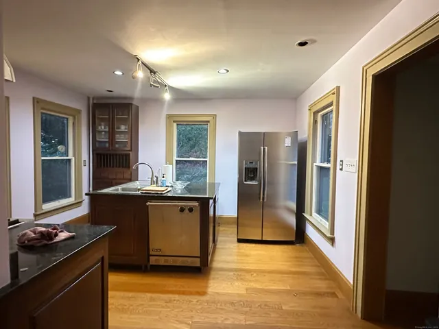 a kitchen with stainless steel appliances granite countertop a refrigerator and a stove