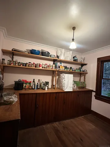 a kitchen with a cabinets and wooden floor