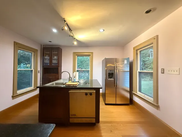 a kitchen with stainless steel appliances granite countertop a refrigerator and a sink