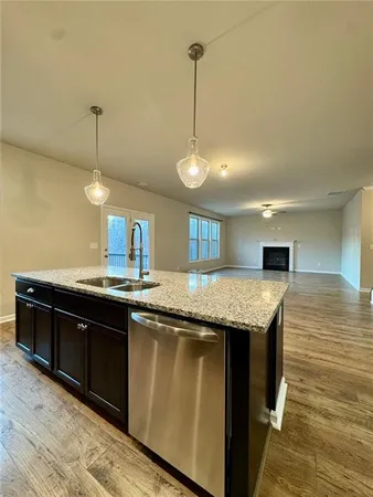 a kitchen with granite countertop cabinets and wooden floor