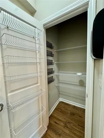 a view of walk in closet with empty racks