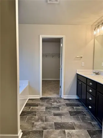 a bathroom with a tub and window
