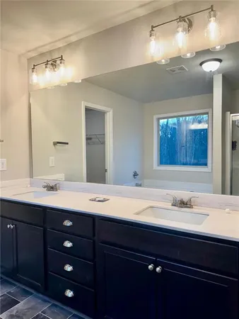 a white toilet sitting in a bathroom next to a sink