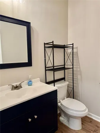 a bathroom with a toilet a sink and mirror