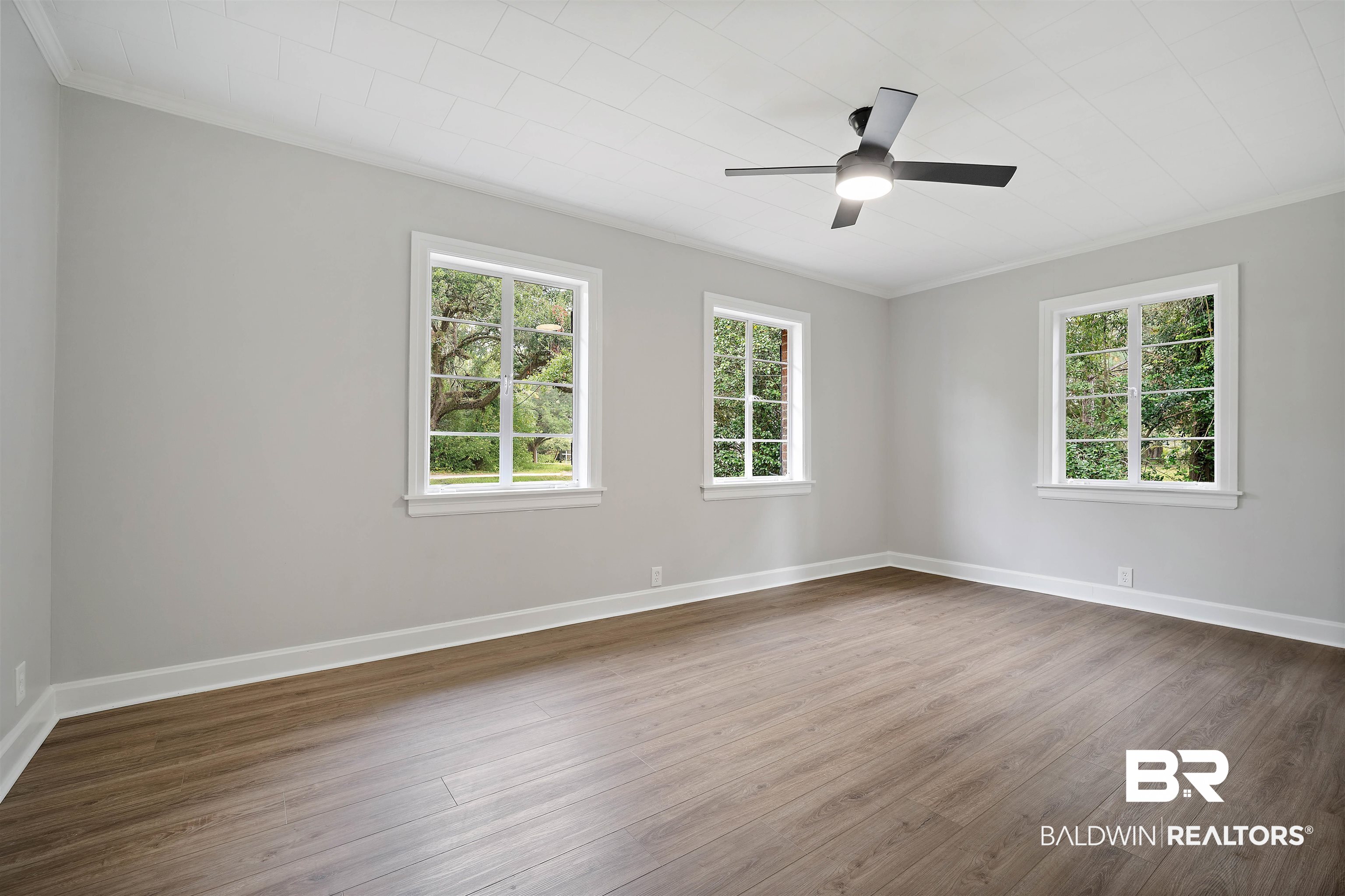 2261 Island Road Mobile, AL 36605 - Photo 14 of 25 Spare room featuring ornamental molding, dark wood-style flooring, plenty of natural light, and a ceiling fan