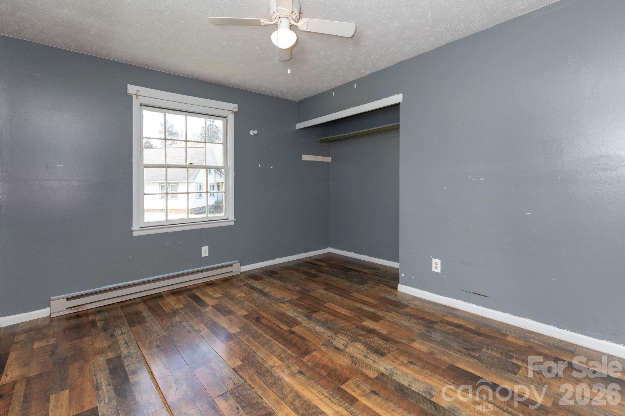 380 Woodland Church Road Clyde, NC 28721 - Photo 14 of 23 wooden floor in an empty room with a window