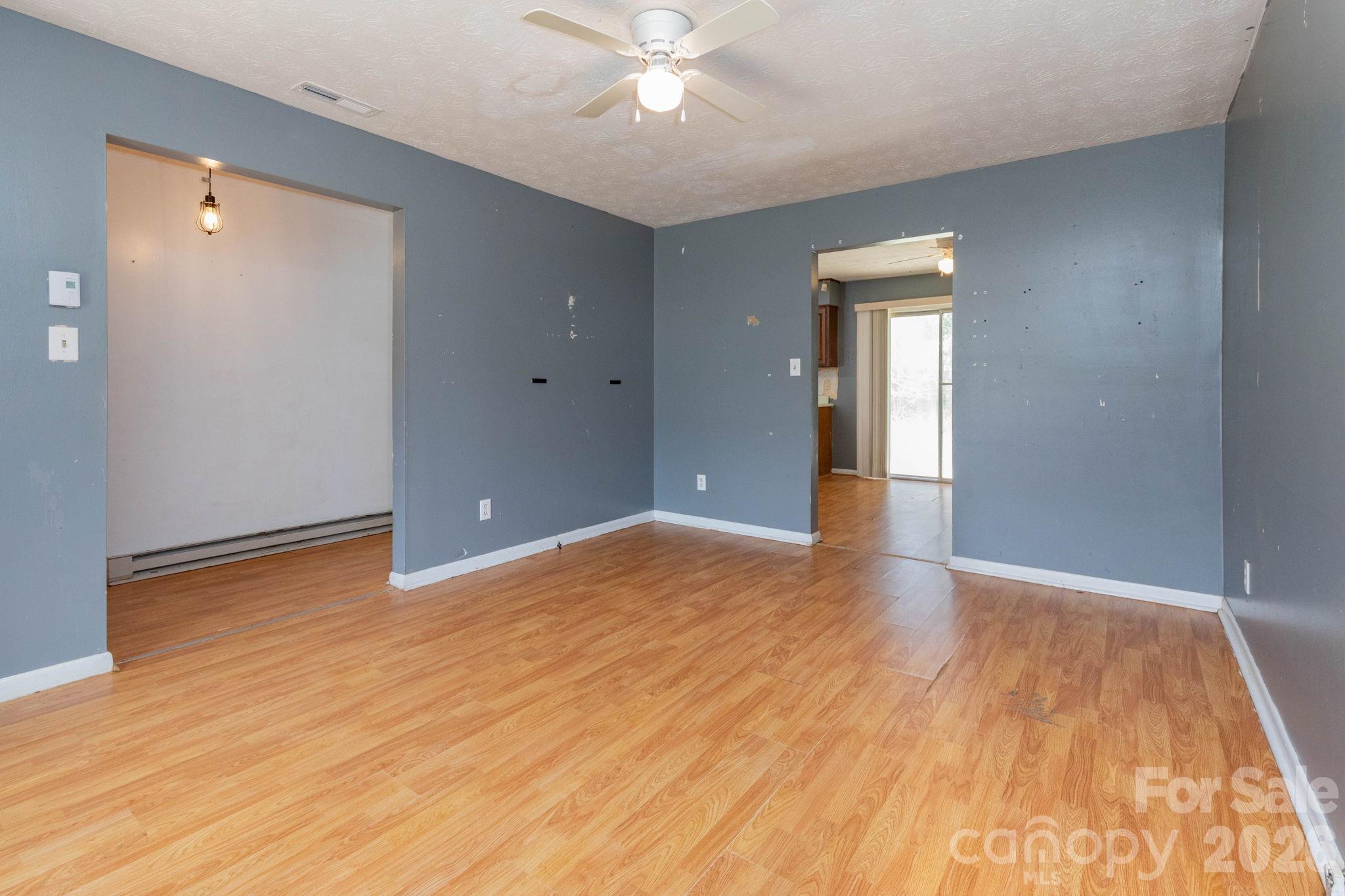 380 Woodland Church Road Clyde, NC 28721 - Photo 2 of 23 wooden floor in an empty room with a window