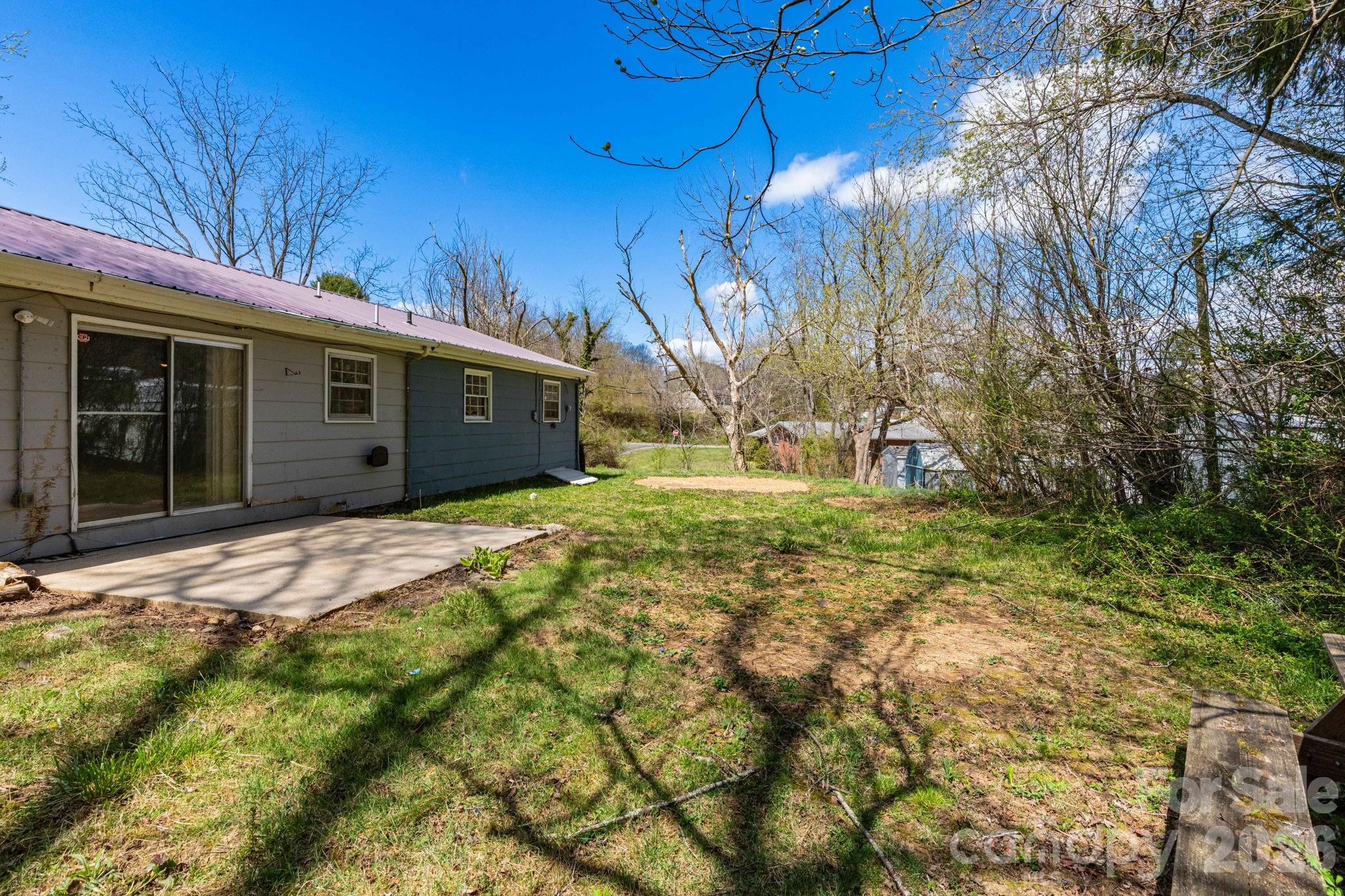 380 Woodland Church Road Clyde, NC 28721 - Photo 22 of 23 a view of a house with a yard