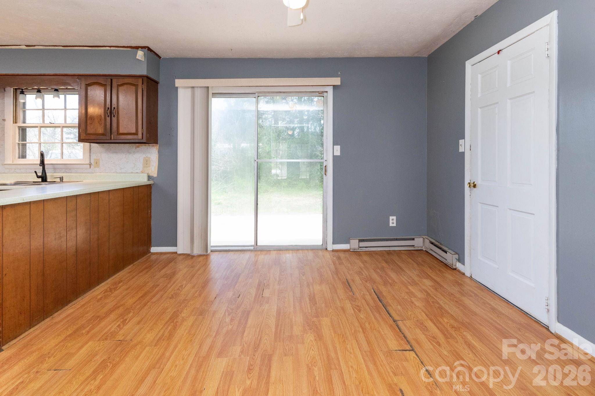 380 Woodland Church Road Clyde, NC 28721 - Photo 7 of 23 a view of an empty room with window and wooden floor