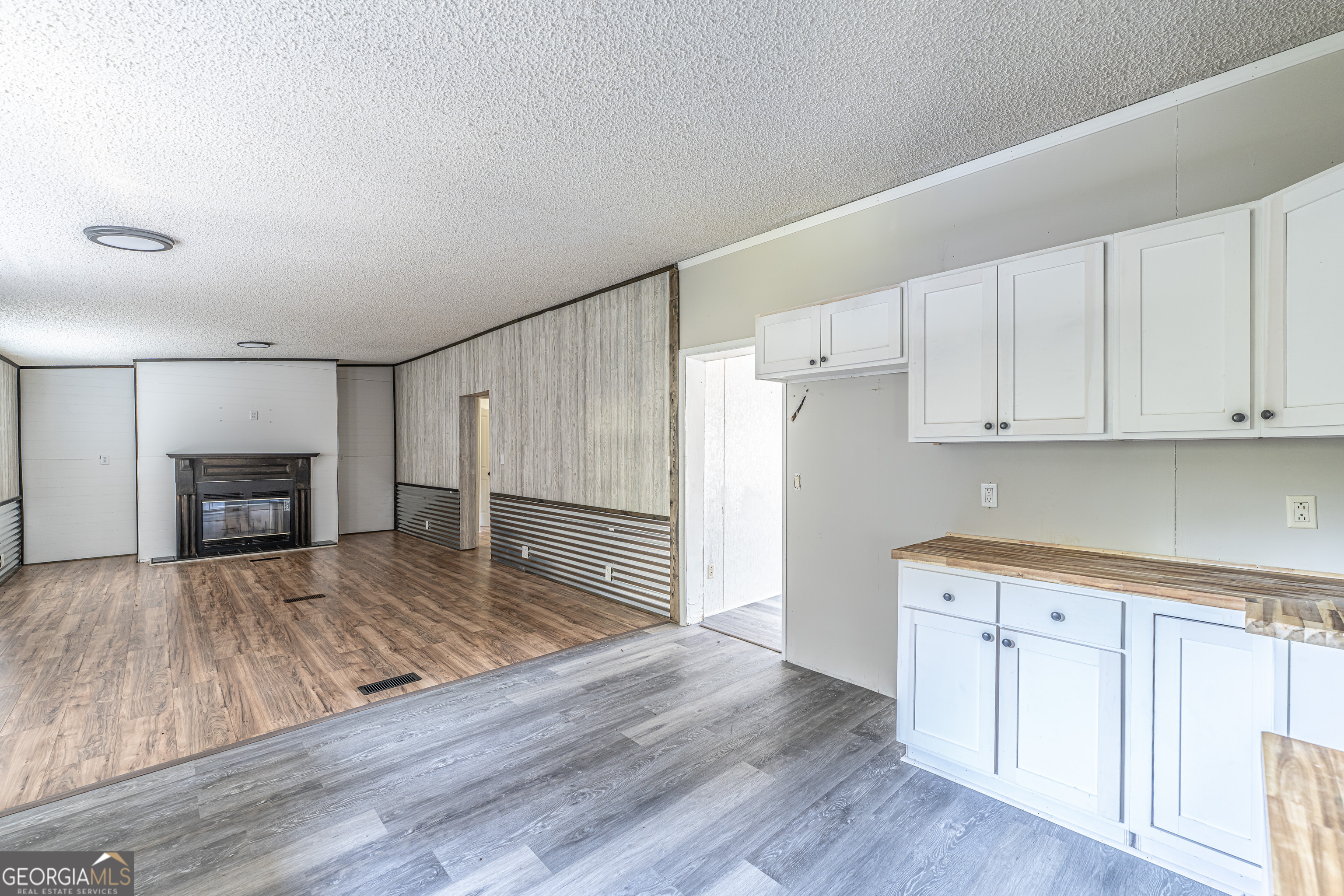 71 Kirk Road Northwest White, GA 30184 - Photo 11 of 43 a kitchen with wooden floors and fireplace