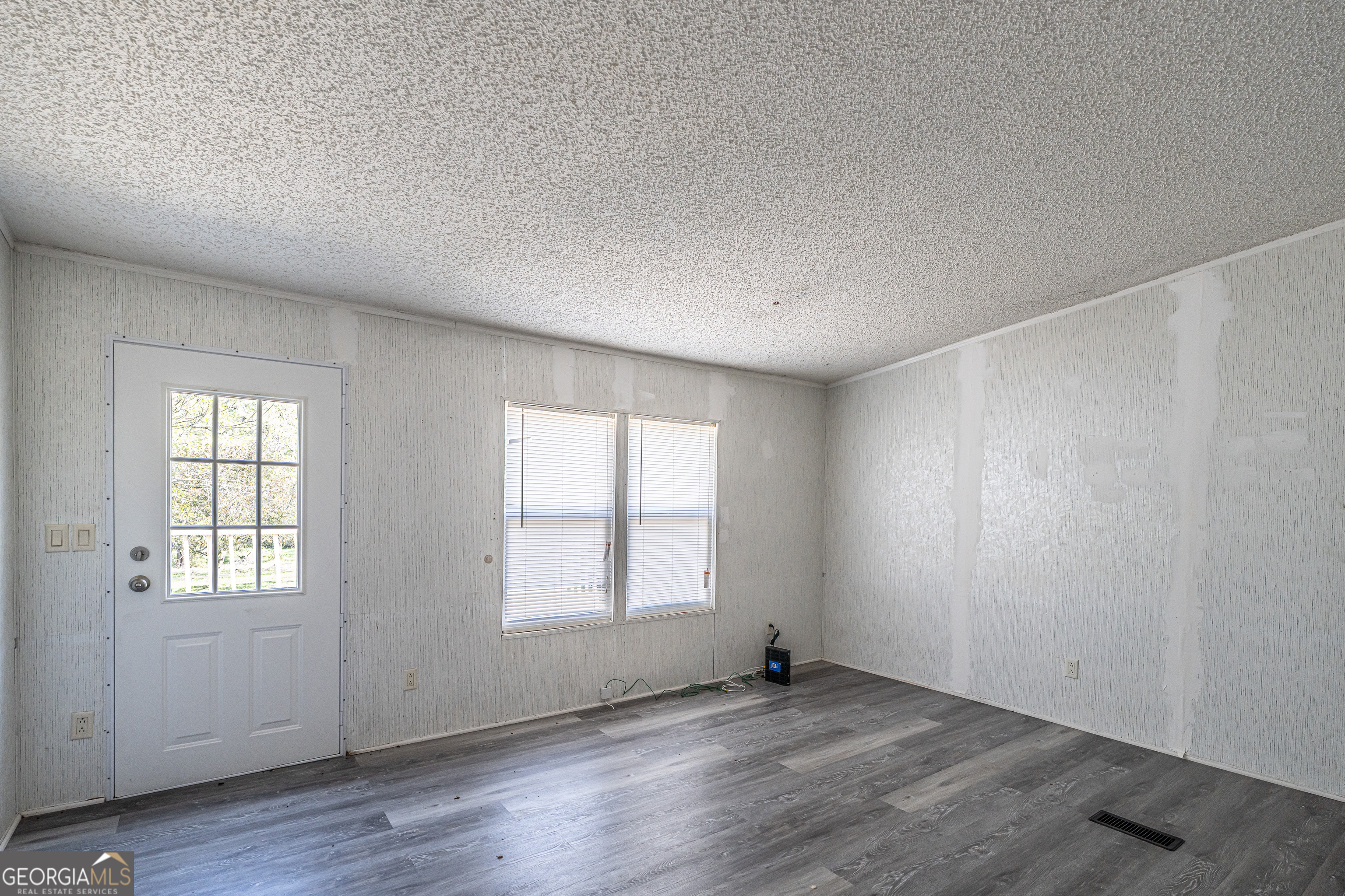 71 Kirk Road Northwest White, GA 30184 - Photo 17 of 43 an empty room with wooden floor and windows