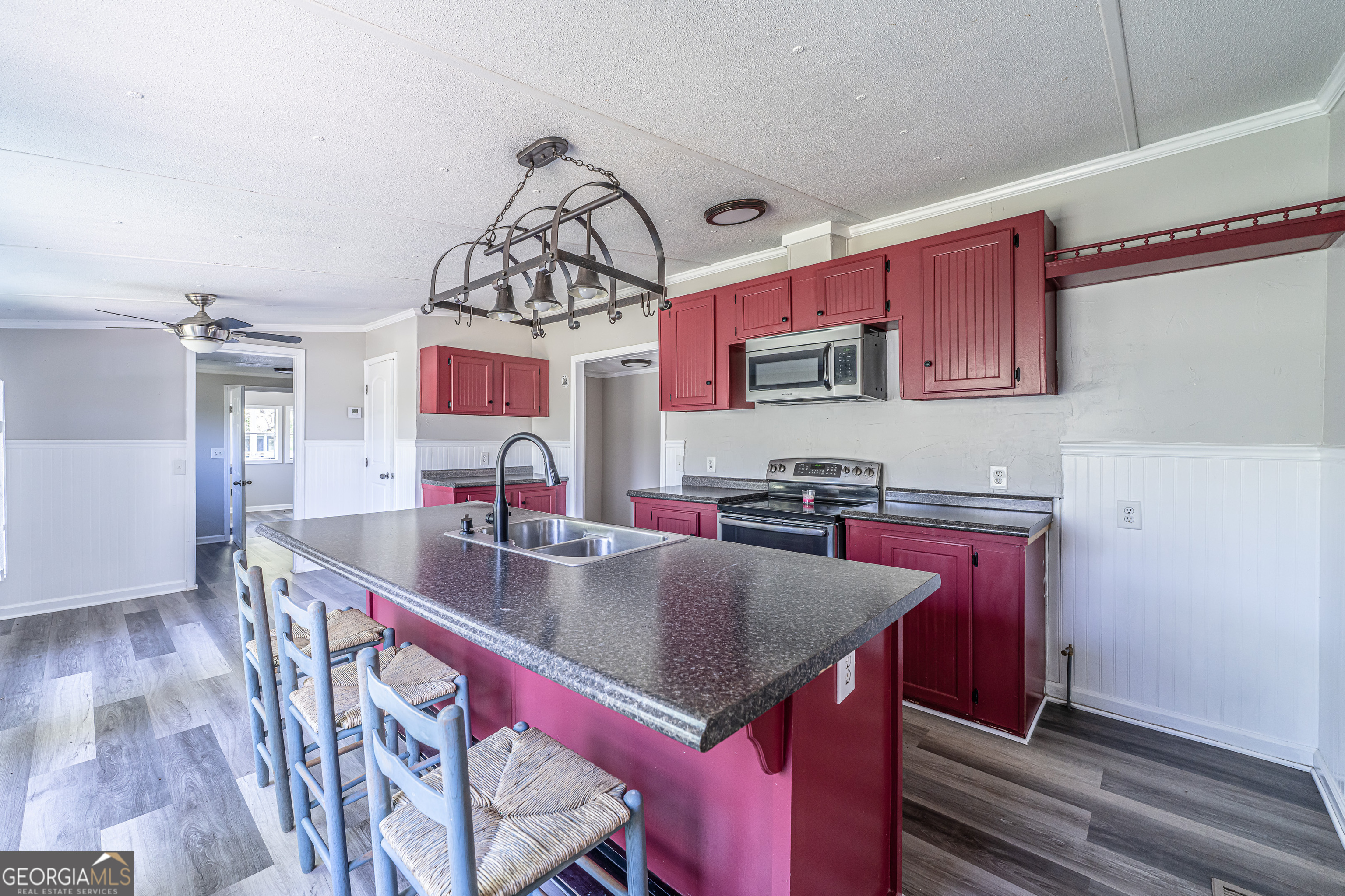 71 Kirk Road Northwest White, GA 30184 - Photo 20 of 43 a kitchen with stainless steel appliances granite countertop a sink dishwasher a stove a refrigerator with a dining table and chairs