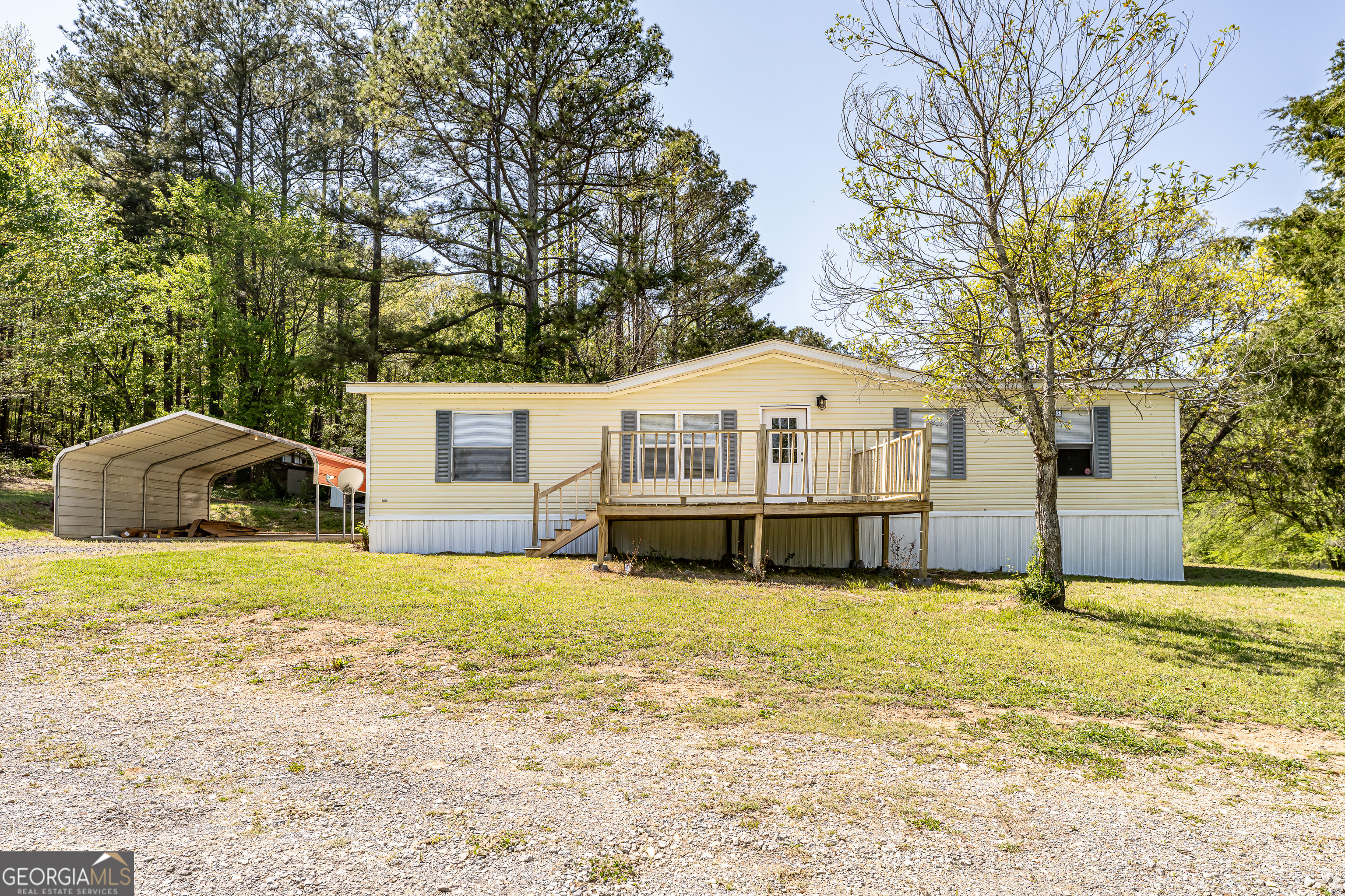 71 Kirk Road Northwest White, GA 30184 - Photo 2 of 43 a front view of house with yard and trees in the background