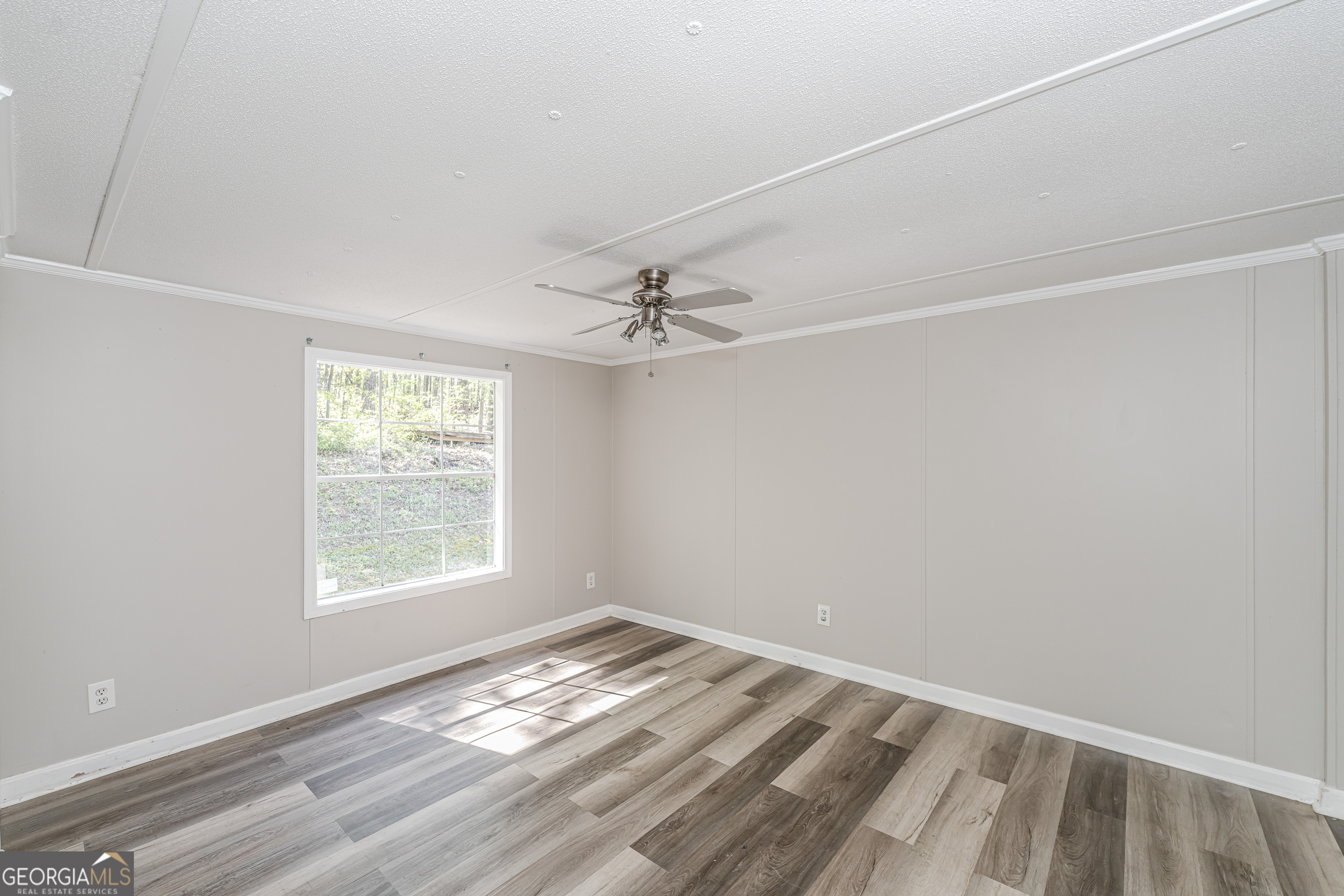 71 Kirk Road Northwest White, GA 30184 - Photo 32 of 43 an empty room with a window and ceiling fan