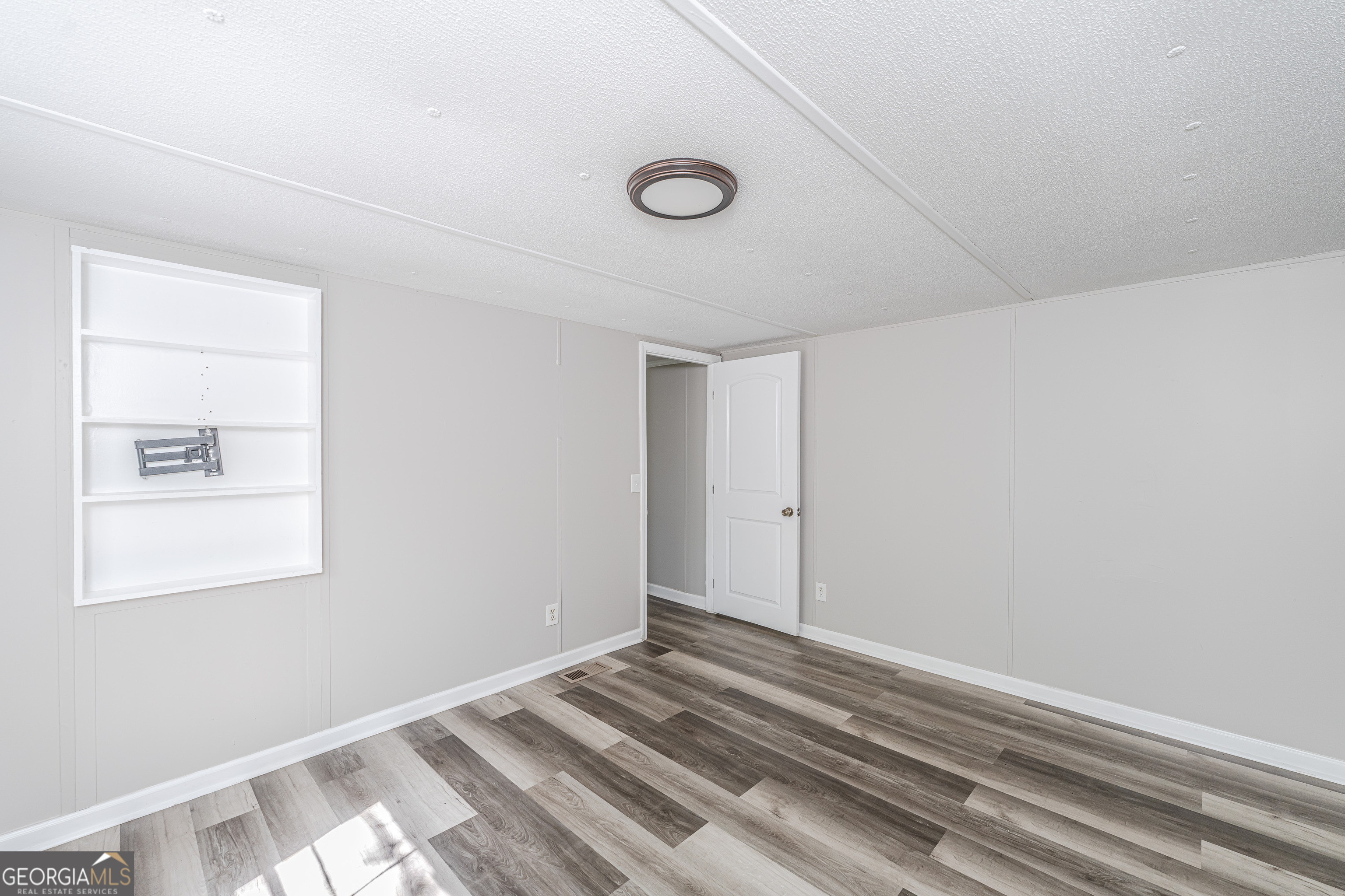 71 Kirk Road Northwest White, GA 30184 - Photo 35 of 43 a view of a livingroom with wooden floor and closet