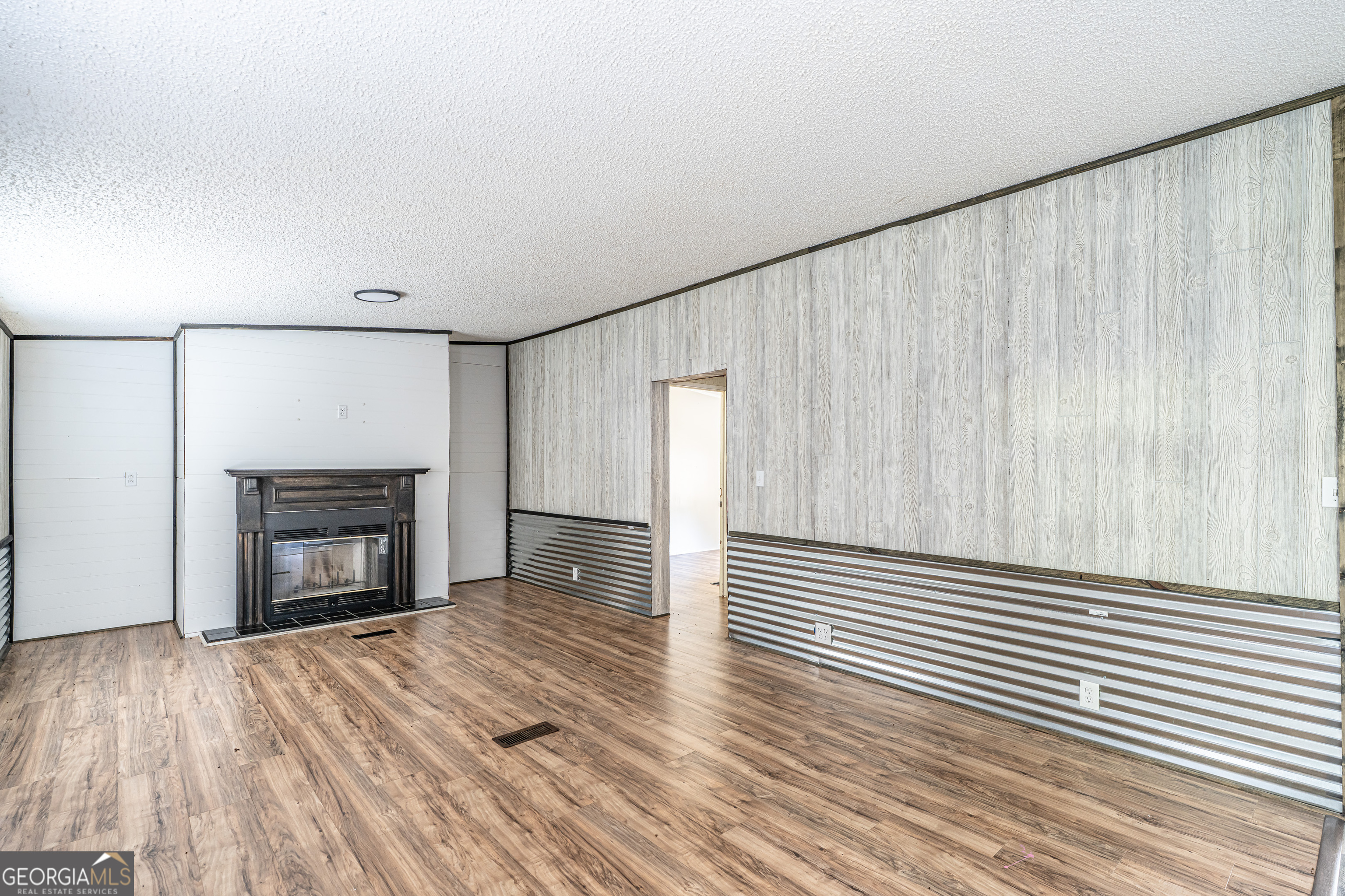 71 Kirk Road Northwest White, GA 30184 - Photo 5 of 43 a view of a livingroom with wooden floor and a fireplace