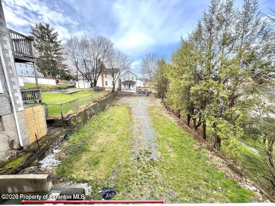 636 Beech Street, Unit 2 Scranton, PA 18505 - Photo 25 of 26 a view of yard with swimming pool and trees in the background