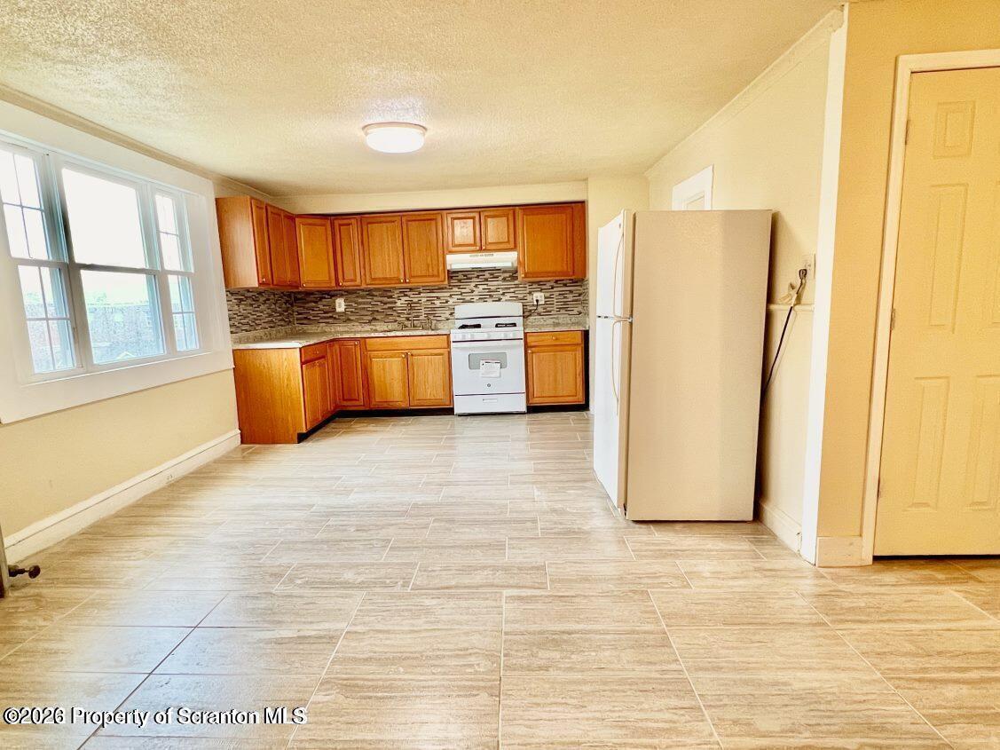 636 Beech Street, Unit 2 Scranton, PA 18505 - Photo 4 of 26 a kitchen with stainless steel appliances a refrigerator and a stove top oven