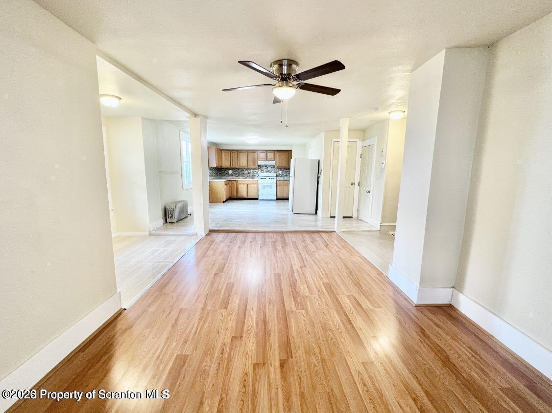 636 Beech Street, Unit 2 Scranton, PA 18505 - Photo 5 of 26 a view of a big room with wooden floor a ceiling fan and closet area