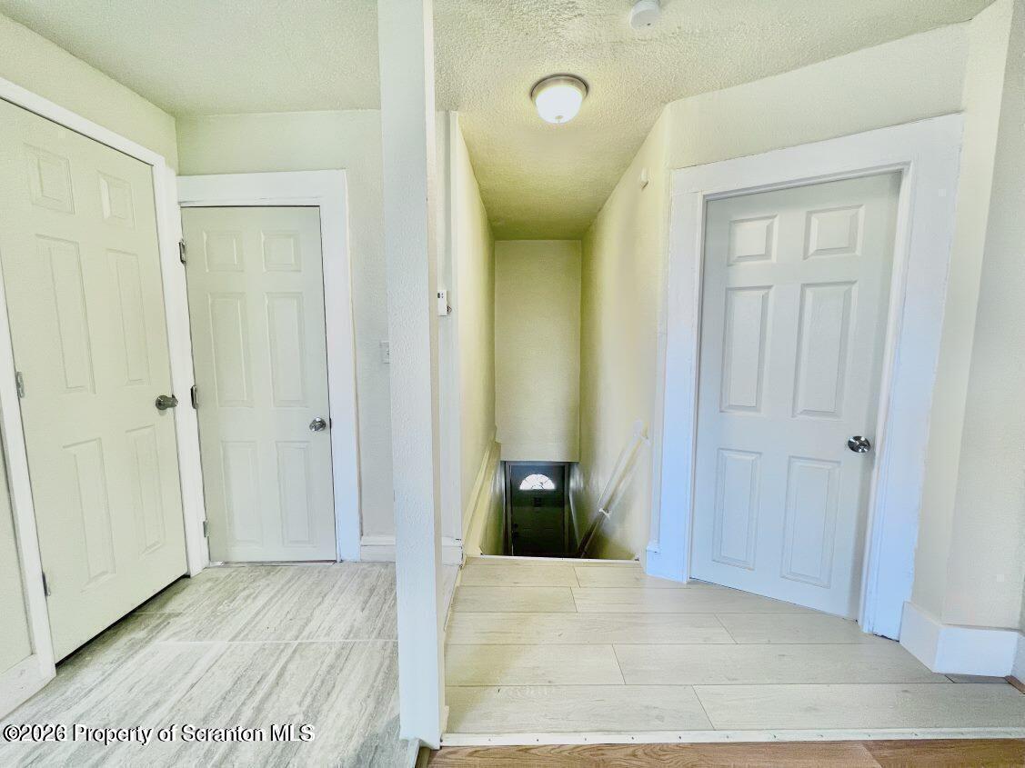 636 Beech Street, Unit 2 Scranton, PA 18505 - Photo 8 of 26 a view of a hallway with wooden floor and closet area