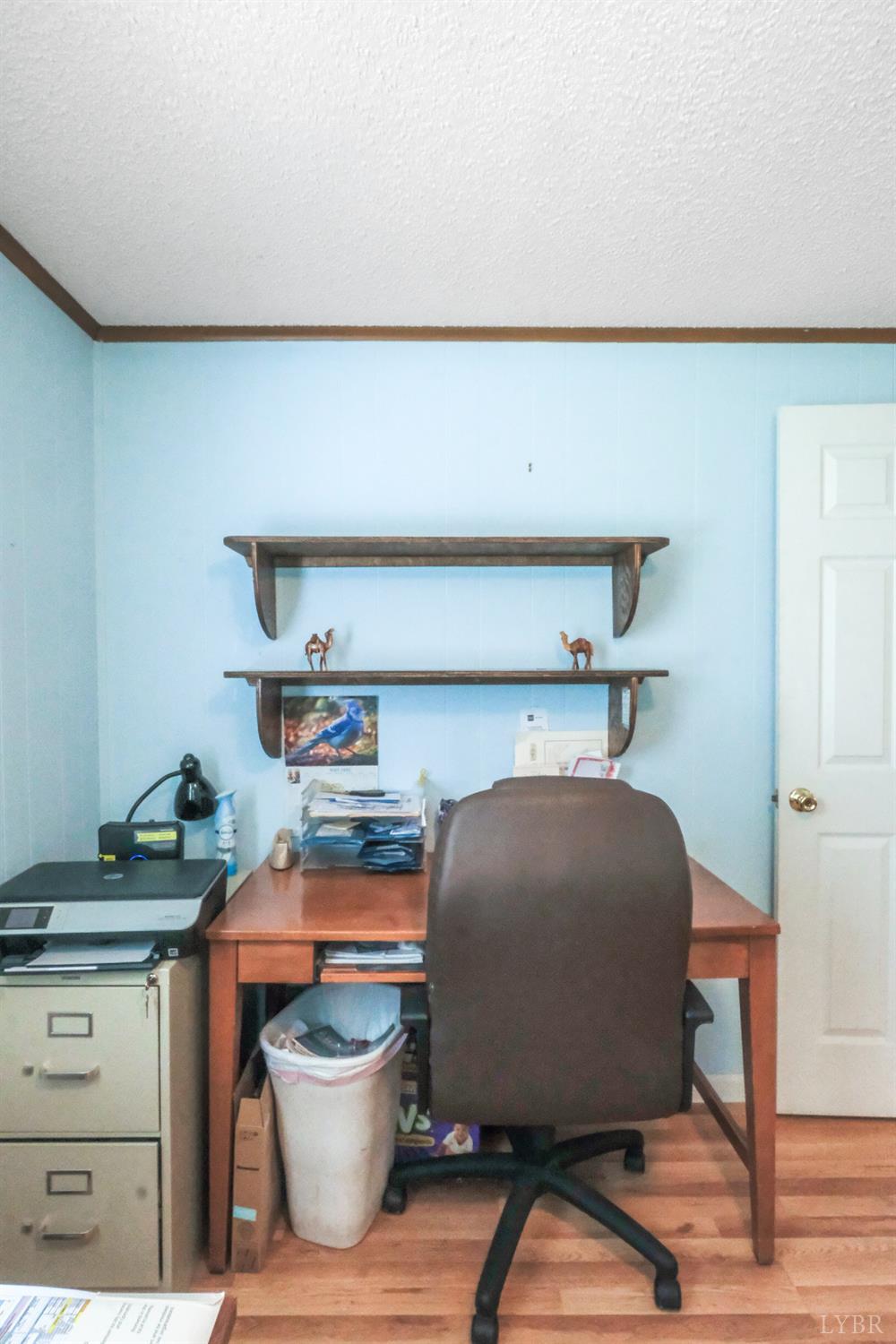 200 Carden Road Phenix, VA 23959 - Photo 14 of 45 a room with a lamp and wooden floor