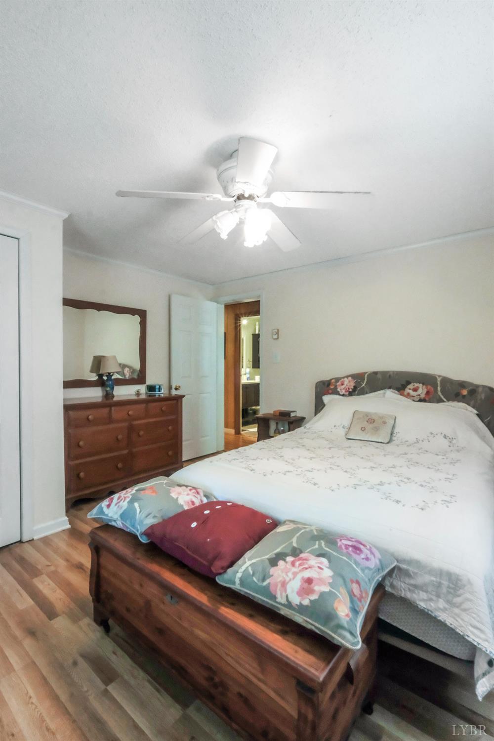 200 Carden Road Phenix, VA 23959 - Photo 15 of 45 a bedroom with a bed and a chandelier