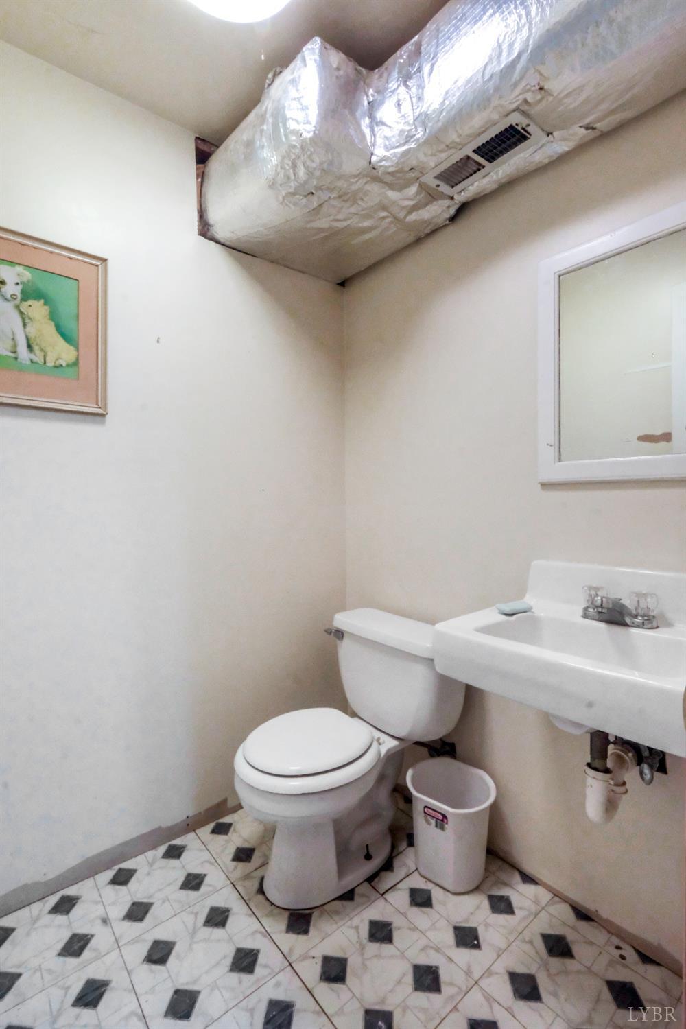 200 Carden Road Phenix, VA 23959 - Photo 28 of 45 a white toilet sitting next to a bathroom sink