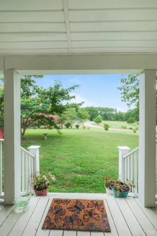 a view of balcony with wooden floor and outdoor seating