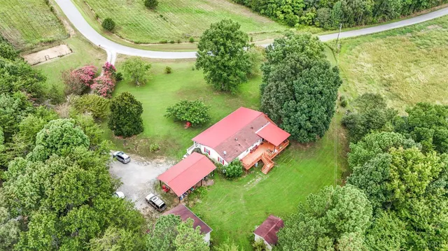 an aerial view of residential houses with outdoor space and street view