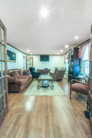 a living room with furniture gym equipment and a view of kitchen