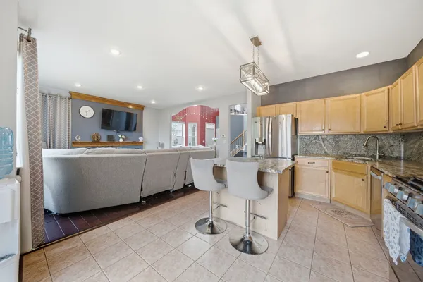 a large kitchen with a table and chairs in it