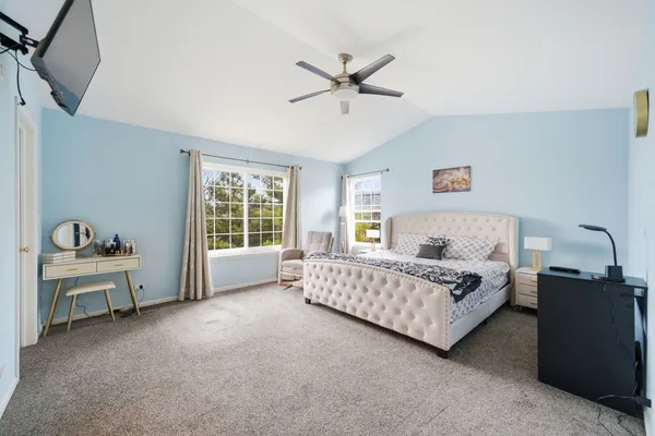a spacious bedroom with a bed and a table