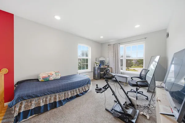 a bedroom with furniture and a window