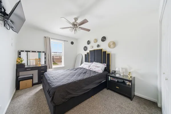 a spacious bedroom with a bed and a chandelier