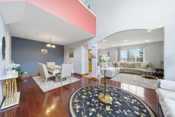 a living room with furniture a rug and a table