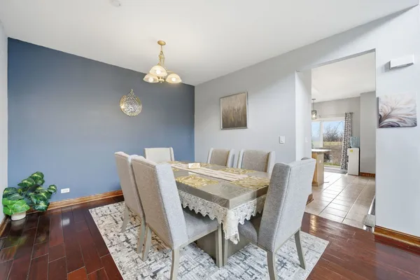 a view of a dining room with furniture wooden floor and a chandelier