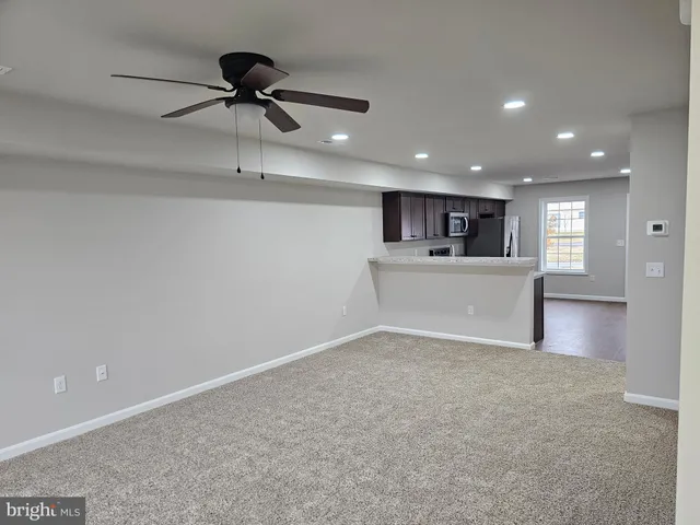 a view of a kitchen with a sink and a refrigerator