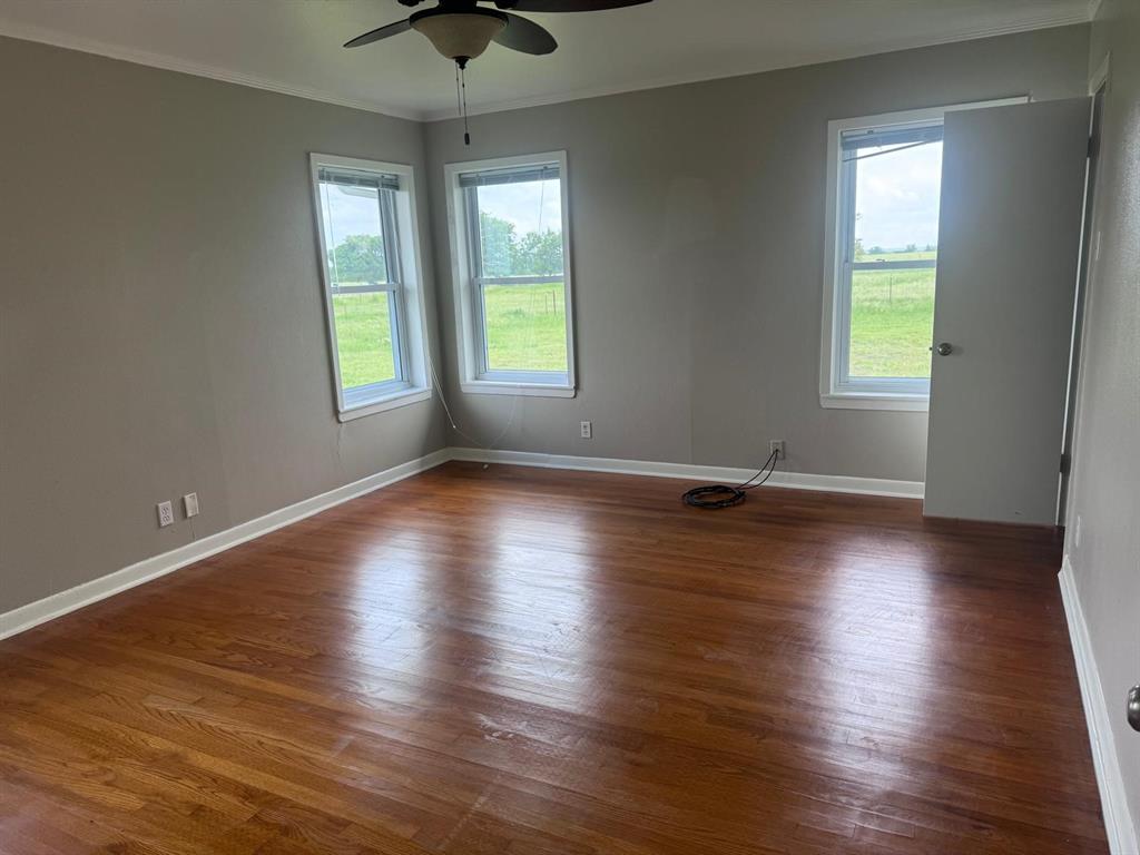 626 Stiff Chapel Road Gunter, TX 75058 - Photo 21 of 40 an empty room with wooden floor and windows