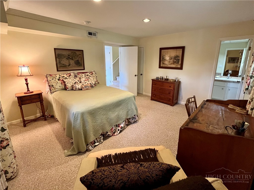 638 Ridge Road Glade Valley, NC 28627 - Photo 20 of 44 a bedroom with a bed a couch and dresser