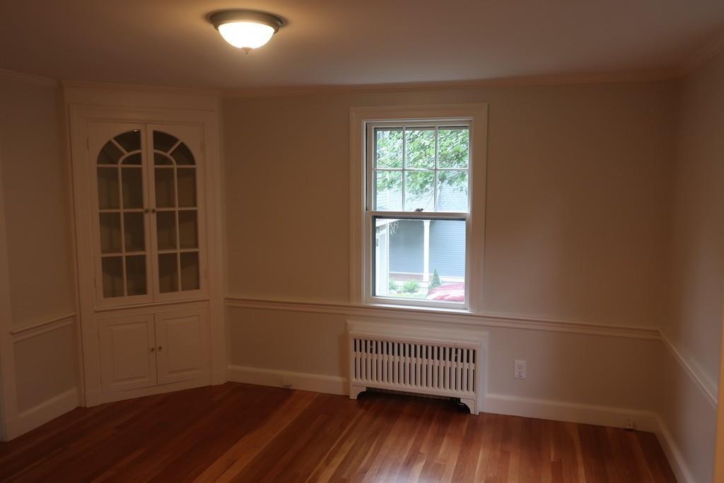 4 Payson Street Lexington, MA 02421 - Photo 12 of 22 an empty room with wooden floor and windows