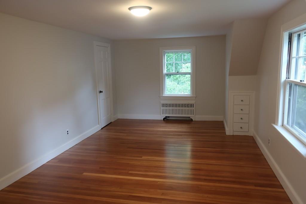 4 Payson Street Lexington, MA 02421 - Photo 13 of 22 an empty room with wooden floor and windows