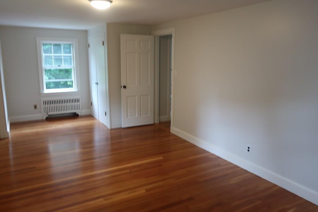 4 Payson Street Lexington, MA 02421 - Photo 14 of 22 an empty room with wooden floor and windows