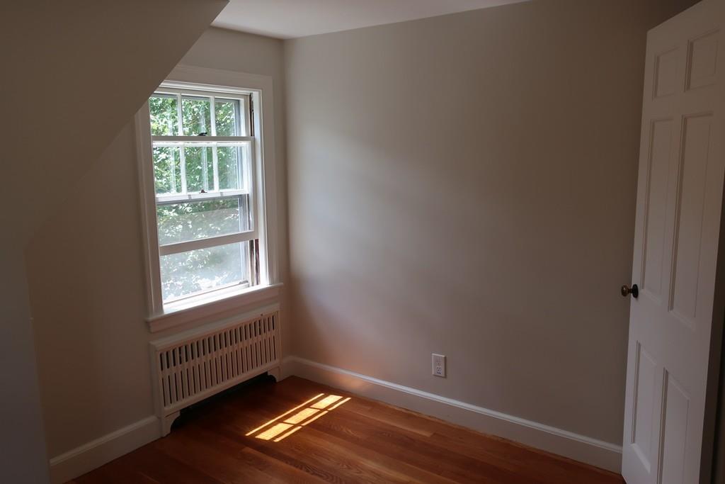 4 Payson Street Lexington, MA 02421 - Photo 16 of 22 an empty room with wooden floor and windows
